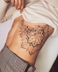 a woman with a tattoo on her stomach