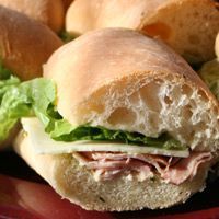 a close up of a sandwich on a plate with lettuce