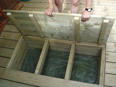 a person standing on top of a wooden floor next to a pool with water in it