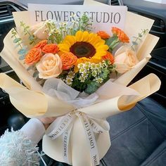 a bouquet of flowers sitting on top of a car seat