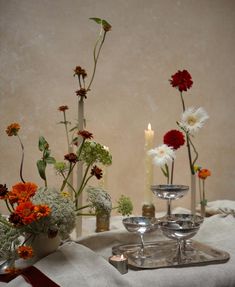 flowers and candles are sitting on a table