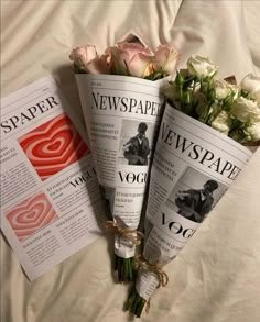 three newspapers are laying on a bed with flowers