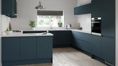 a kitchen with grey cabinets and wooden floors