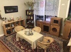 a living room filled with furniture and a table covered in a white clothed table cloth