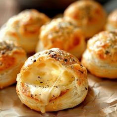 several small rolls with cheese and black pepper sprinkled on them