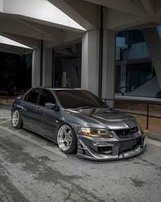 a silver car parked in front of a building