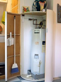 an old fashioned water heater in the corner of a room with a checkered floor