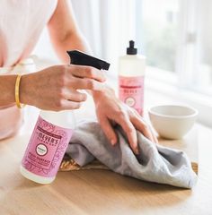 a woman is drying her hands with a cloth on the table next to some other items