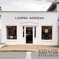 the front entrance to lauren morgan's clothing store, which is located on an empty street