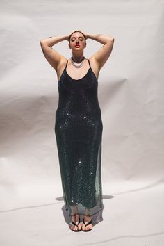 Our iconic slip dress silhouette now in a shining crystal stone mesh! Hundreds of metallic finish hematite stones catch just the right amount of light, making this truly elevated and perfect for a night out. Our mesh has a net-like fabrication covered in perfectly placed crystals. The soft black straps are adjustable for the perfect fit. 59" Shoulder to hem. This weighty dress comes with a separate black slip made of jersey fabric so you can wear it with as much or little underneath that you lik Metallic Shiny Sequin Evening Dress, Metallic Shiny Sequin Dress For Evening, Metallic Sequin Dress For Evening, Evening Metallic Sequin Dress, Mesh Slip Dress, Satin Blazer, Hematite Stone, Silver Ear Cuff, Dress Silhouette