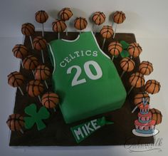 a cake made to look like a basketball jersey with the number 20 on it, surrounded by cupcakes