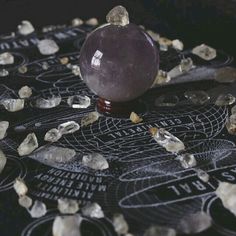 an apple sitting on top of a table surrounded by rocks and crystals, with the word cut above it