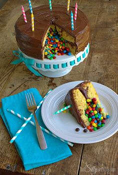 a piece of birthday cake with chocolate frosting and sprinkles on a plate