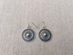 "These are unique and highly detailed boho disc earrings. They have a unique eye catching design and would be perfect for everyday wear. They measure 7/8\" across by 1\" long and hang from simple elegant ear wires. The earrings are made from allergy free plated silver. I have a matching necklace in my shop, if you would like the whole set. Here is the link https://etsy.me/2X6CB2r Thanks for stopping by. Please take a moment and visit the rest of my shop. I have many more unique jewelry designs t Silver Southwestern Round Earrings, Southwestern Style Festival Earrings, Southwestern Style Round Festival Earrings, Southwestern Style Festival Round Earrings, Southwestern Metal Earrings For Gift, Southwestern Style Metal Earrings For Gift, Adjustable Drop Earrings With Sun Design, Adjustable Southwestern Round Earrings, Nickel-free Southwestern Style Festival Earrings