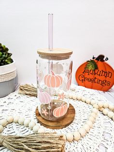 a glass with a straw in it sitting on top of a doily covered table