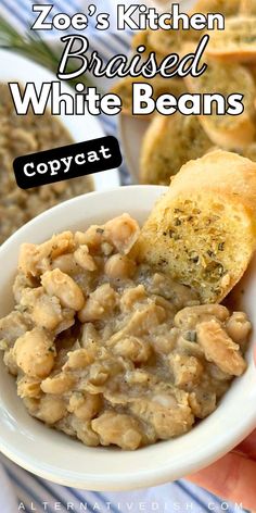 a white bowl filled with food next to bread