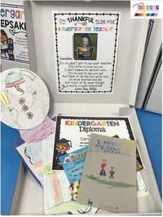 an open box with children's artwork and paper