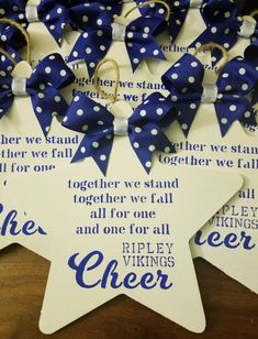 blue and white polka dot star shaped plaques with sayings on the sides, hanging from twine strings