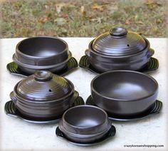 four pots and pans sitting on top of a table