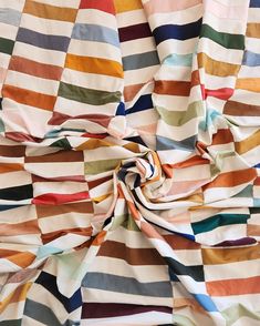 multicolored striped fabric with white, red, blue, yellow and green stripes