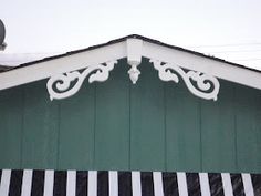 a green building with white and black stripes