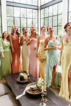 a group of women standing next to each other in front of a table with candles