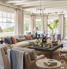 a living room filled with furniture and lots of windows