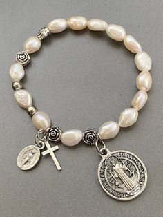 "Item details Handmade Rosary Bracelet for Women Stretch Bracelets, St Benedict, miraculous medal and small cross The size of the bracelet is 6'5\" This will be a great gift for confirmation! A unique and beautiful personalized rosary bracelet! It will make a perfect religious themed gift or inspiration for yourself. The beads used on every piece are handpicked. We make sure that each bracelet includes a range of the natural colors found in the stone It is not guaranteed to look exactly the same Elegant Adjustable Rosary Bracelet, Cheap Personalized Rosary Bracelet Gift, Rosary Jewelry, Prayer Bracelet, St Benedict, Catholic Jewelry, Rosary Bracelet, Beads Bracelet Design, Miraculous Medal