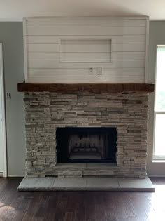 an empty living room with a fireplace in it