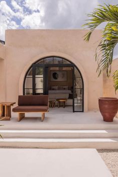 an outdoor patio with seating and potted plants