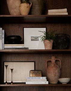 books, vases and other items are on the shelves