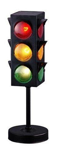 a traffic light on a black stand with red, yellow and green lights in it