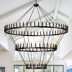 a large chandelier with many candles hanging from it's sides in a living room