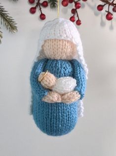 a knitted ornament hanging from a christmas tree