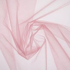 an abstract photo of pink sheer fabric on white background with diagonal lines and curves in the center