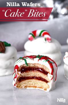 some white cakes with red and green icing on top of each other, one has a bite taken out of it