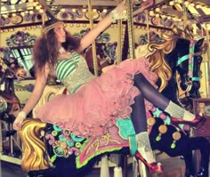 a woman sitting on top of a merry go round