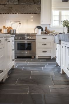 the kitchen is clean and ready for us to use it's tile flooring