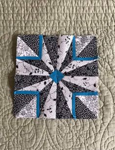 a black and white quilt with blue accents