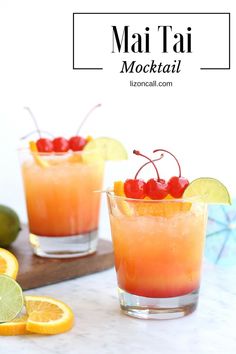 two glasses filled with orange juice and garnished with cherries