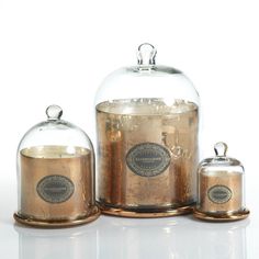 three jars with labels on them sitting next to each other