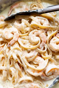 pasta with shrimp and cream sauce in a skillet, ready to be eaten by someone