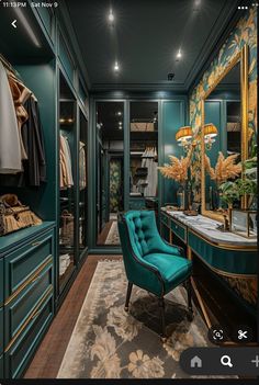 a green chair sitting in front of a walk in closet filled with lots of clothes