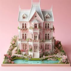 a large pink doll house sitting on top of a table