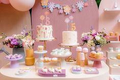 a table topped with lots of cakes and desserts