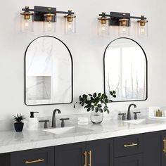 a bathroom with double sinks and two mirrors on the wall next to eachother