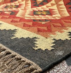 a multi colored rug with fringes on it