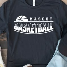 a t - shirt that says mascott basketball on it next to shoes and sneakers