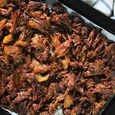 a tray filled with cooked food on top of a table