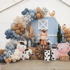 an outdoor display with farm animals and balloons